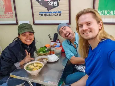 Local guide leading travelers on a private Hanoi Street Food Walking Tour in Hanoi