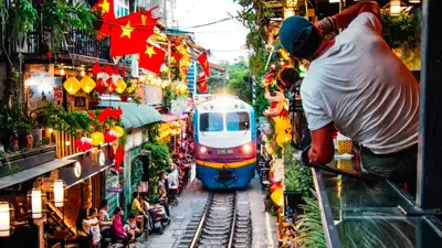 Local guide leading travelers on a private Hanoi Train Street & Hidden Alleys Walking Tour in Hanoi